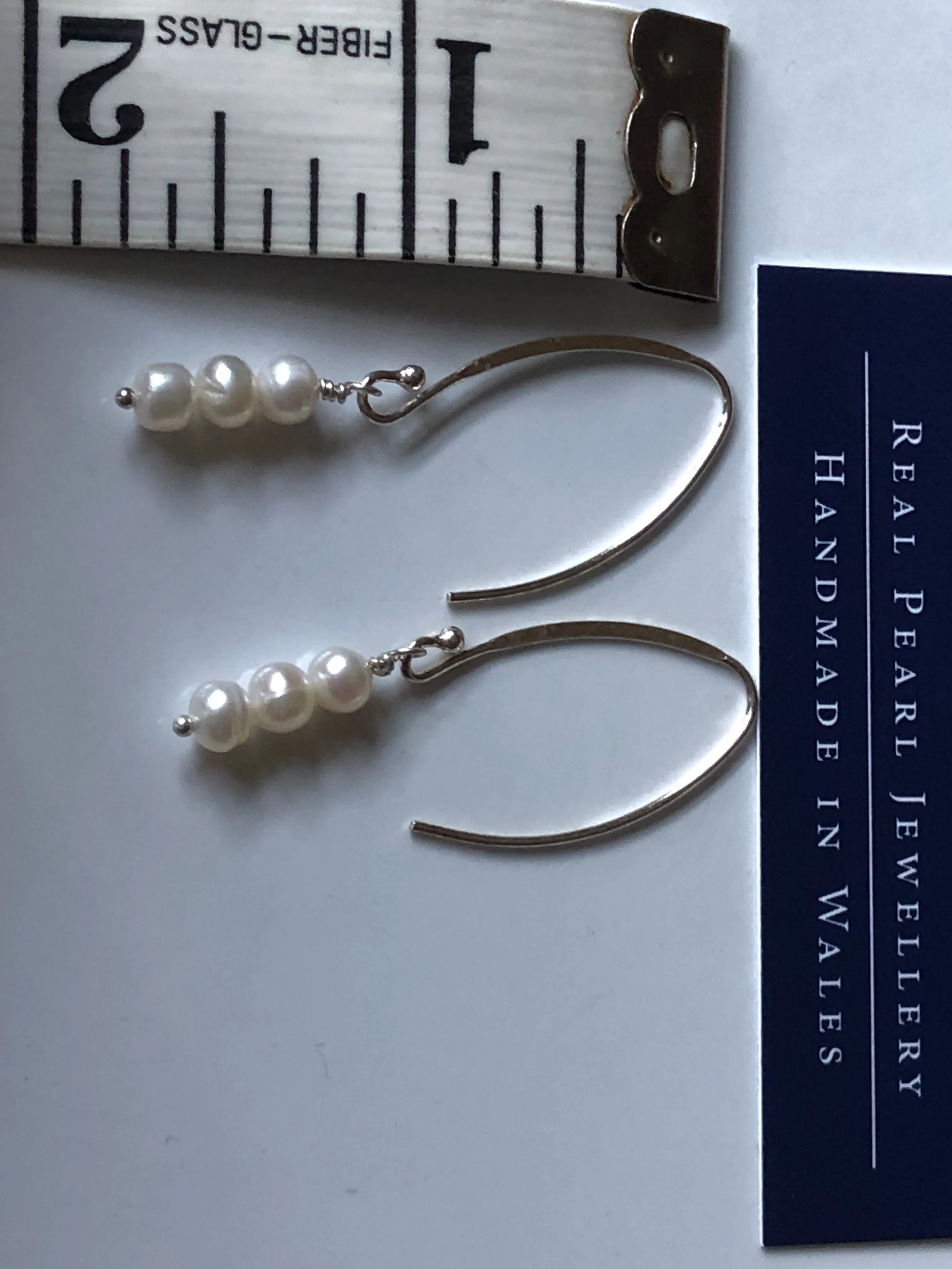 Earrings: Long triple drop Pearl ivory earrings on flat side hooks